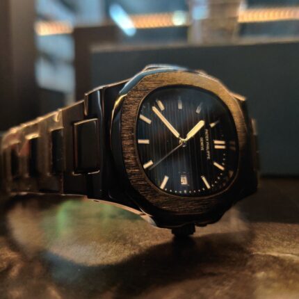 Side view of PP Nautilus Black Shiny Dial showcasing polished case and sleek stainless-steel bracelet.